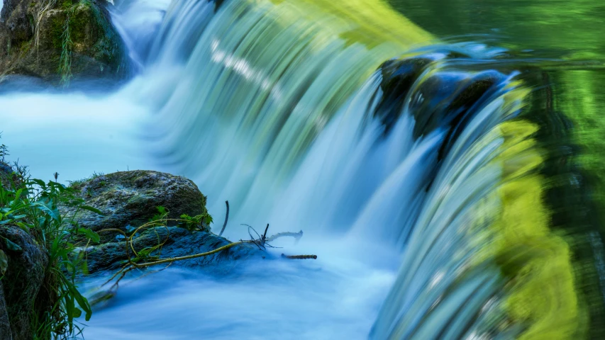 a small waterfall flowing through a lush green forest, by Jan Rustem, pexels contest winner, hurufiyya, blue, dynamic closeup, thumbnail, slide show