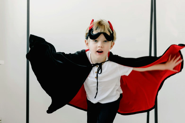 a little boy dressed up as a bat, pexels contest winner, cruella devil, all overly excited, male hero, antigravity