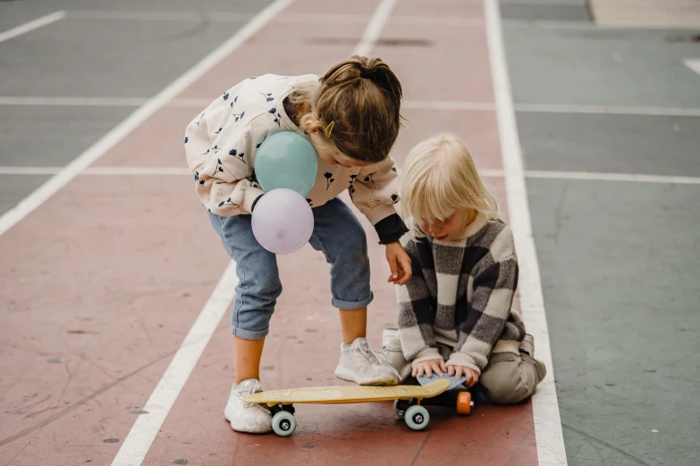 a couple of kids sitting on top of a skateboard, by Winona Nelson, pexels contest winner, activity play centre, holding a balloon, mini model, toddler