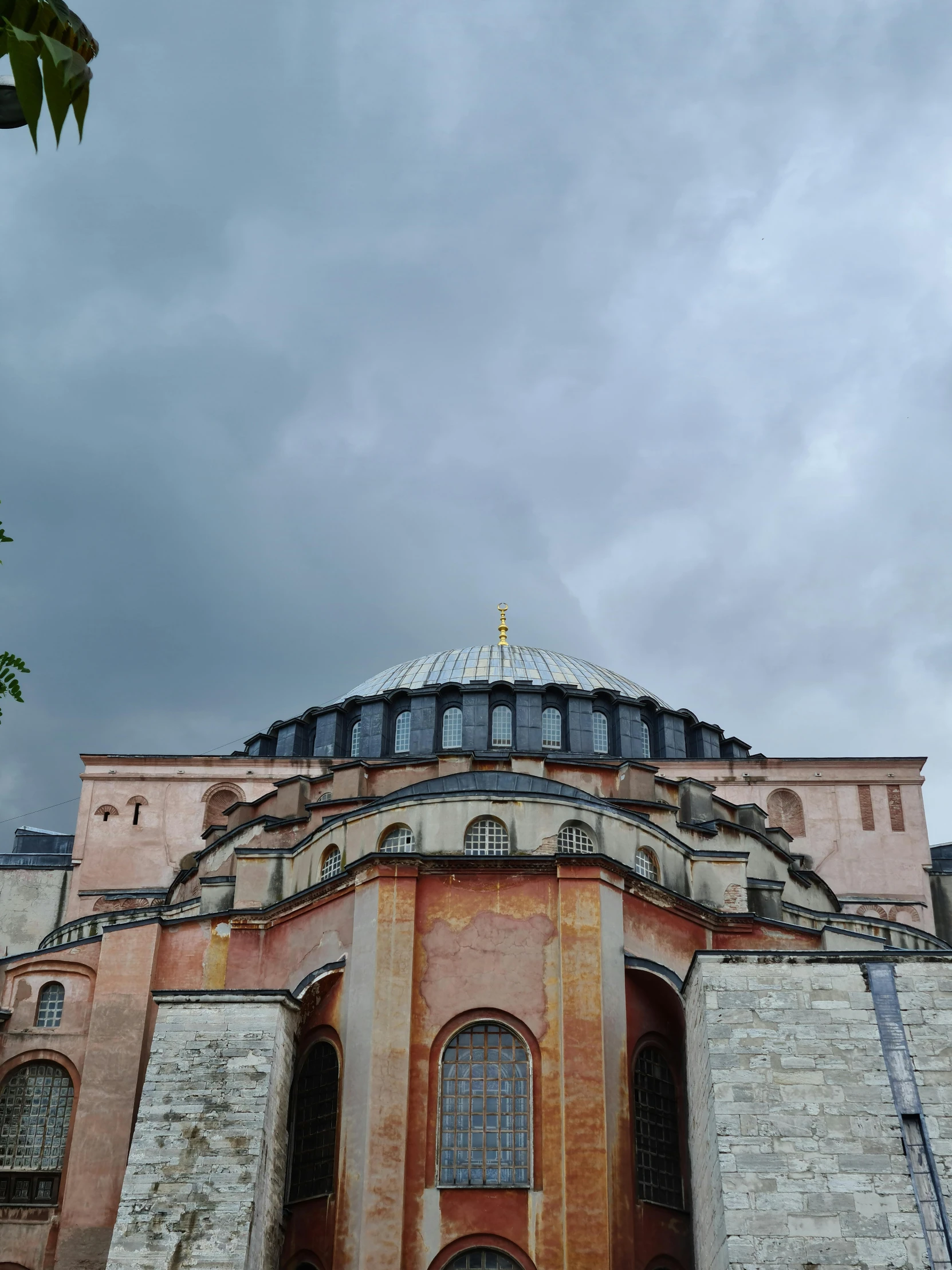 a large building with a dome on top of it, inspired by Osman Hamdi Bey, gloomy skies, view from ground, 🚿🗝📝, byzantine