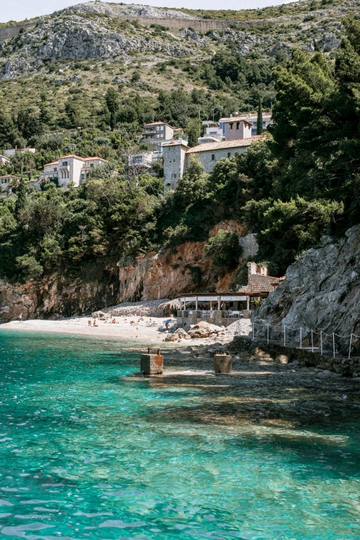 a couple of boats that are in the water, a picture, by Julia Pishtar, trending on unsplash, renaissance, the village on the cliff, 2 5 6 x 2 5 6 pixels, white beaches, built into trees and stone