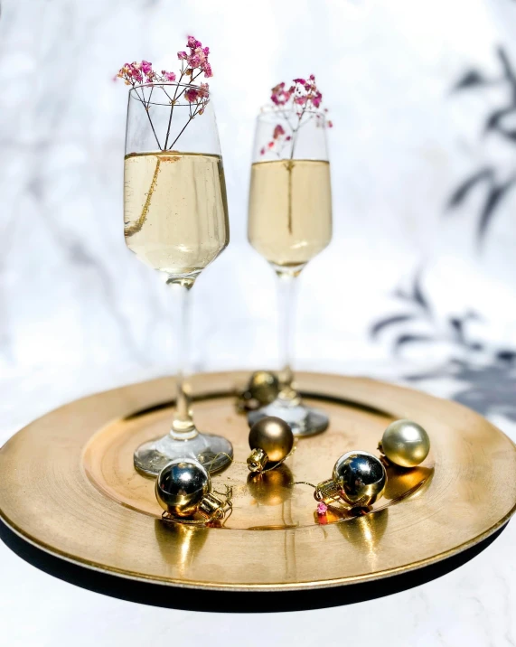 two glasses of champagne on a gold plate, by Alice Mason, happening, glass orbs, miniature product photo, grey, multiple stories