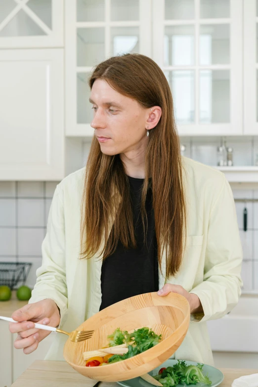 a woman standing in a kitchen preparing a meal, inspired by Wilhelm Hammershøi, trending on reddit, mullet long haircut, handsome man, product introduction photo, plain background