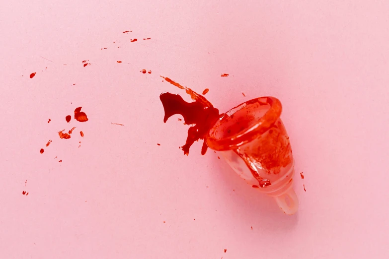 a spilled ice cream cone on a pink surface, an album cover, inspired by Lucio Fontana, trending on pexels, visual art, blood drop, bloody scene, resin, clear shot