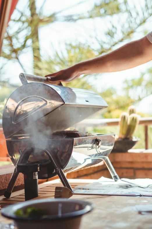 a man is cooking food on a grill, a picture, by Jakob Gauermann, shutterstock, fine art, house kitchen on a sunny day, smokey cannons, thumbnail, instagram picture