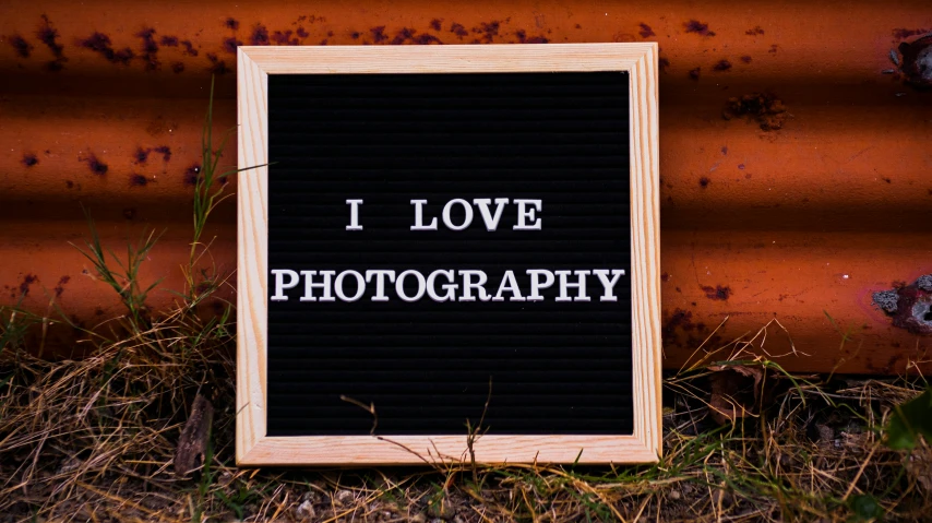 a black board with the words i love photography written on it, a picture, unsplash, exterior photography, sign, professionally post-processed, anthropology photography