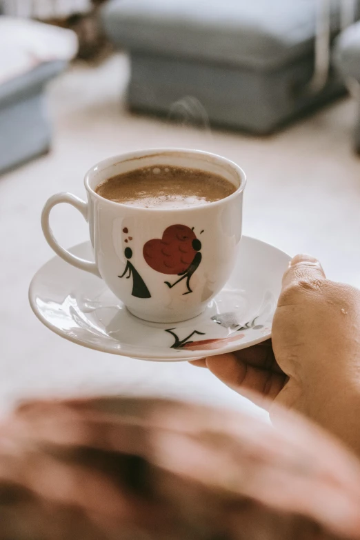 a person holding a cup of coffee on a saucer, cupid, but not quite, full of details, thumbnail