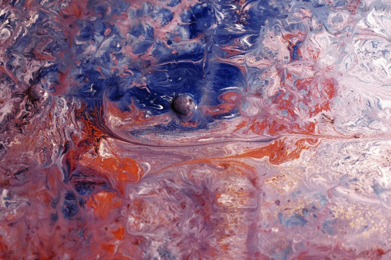 a close up of a liquid substance on a surface, an ultrafine detailed painting, flickr, space art, indigo and venetian red, colored marble, looking towards the camera, taken on a 1990s camera