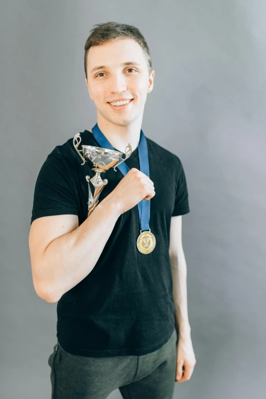 a man with a medal around his neck, a picture, pexels contest winner, young man with short, plain background, winning photo, foil