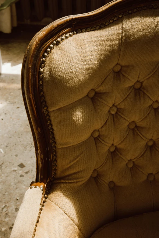 a close up of a chair in a room, an album cover, trending on unsplash, baroque, tufted softly, light brown, made of fabric, cheeks
