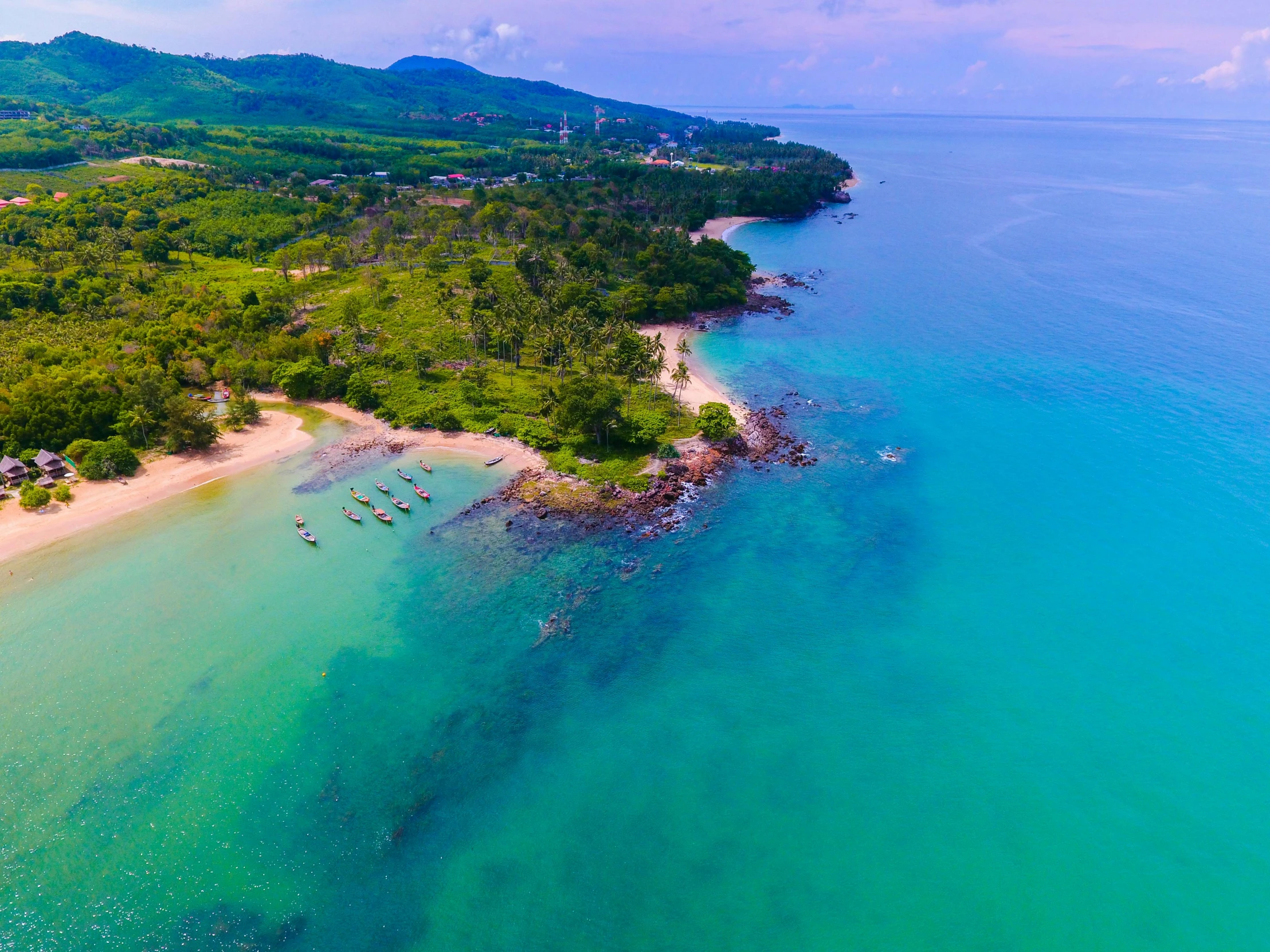 an aerial view of a beach in the middle of the ocean, hurufiyya, vibrant green, thawan duchanee, views to the ocean, fishing village