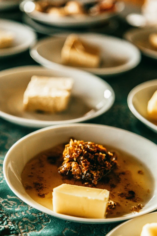 a number of plates of food on a table, by Lee Loughridge, unsplash, renaissance, butter, square, chile, close up of iwakura lain