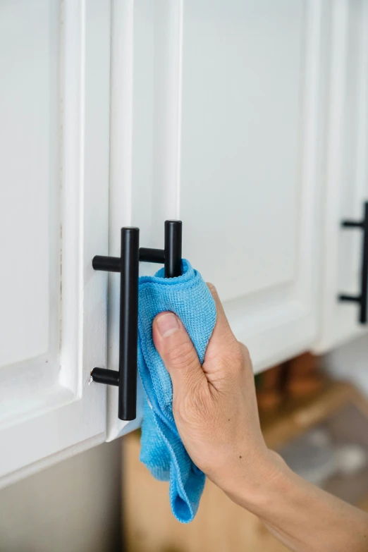 a person cleaning a kitchen cabinet with a micro towel, hp mp stamina bars, upscaled to high resolution, black, metal handles