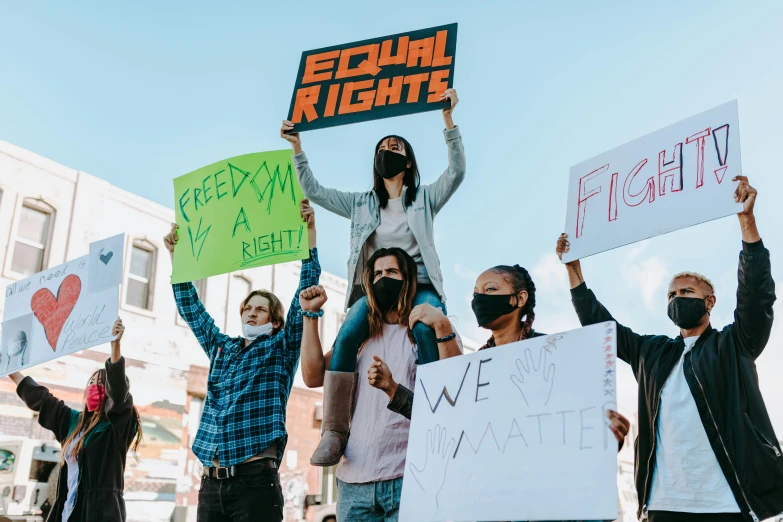 a group of people holding signs in the air, by Julia Pishtar, trending on pexels, gay rights, background image, fights, high school