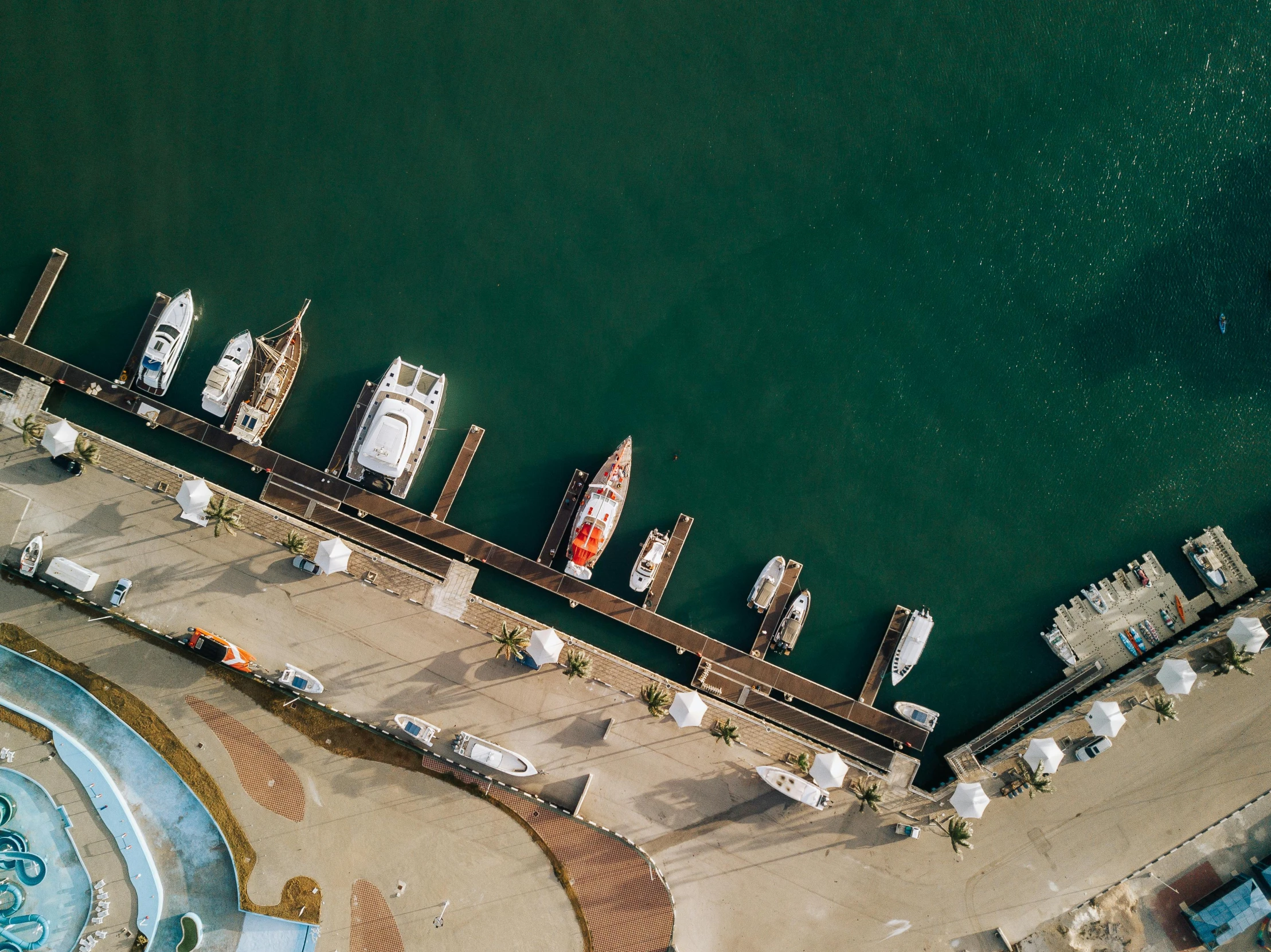 a group of boats sitting on top of a body of water, pexels contest winner, birds eye overhead perspective, docked at harbor, resort, california;