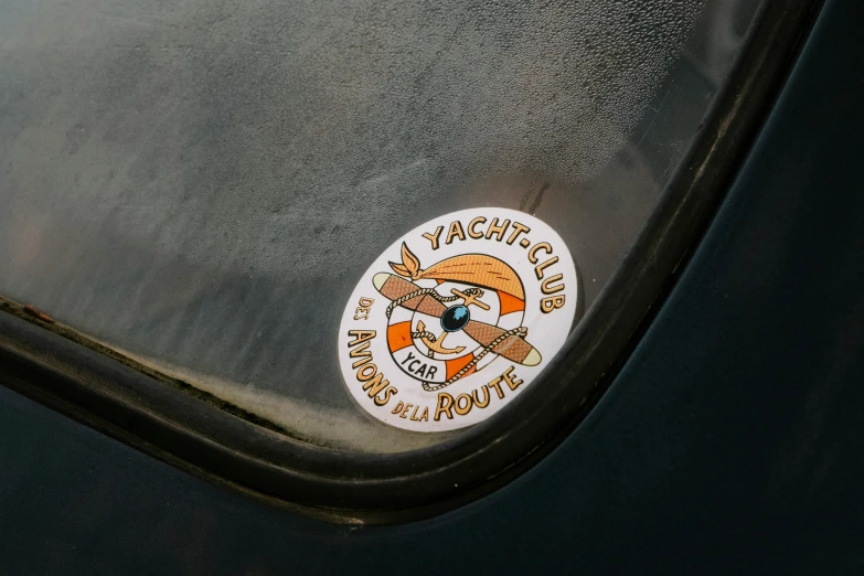 a close up of a sticker on the side of a car, by Thomas Häfner, bored ape yacht club, round about to start, high quality photo, fra