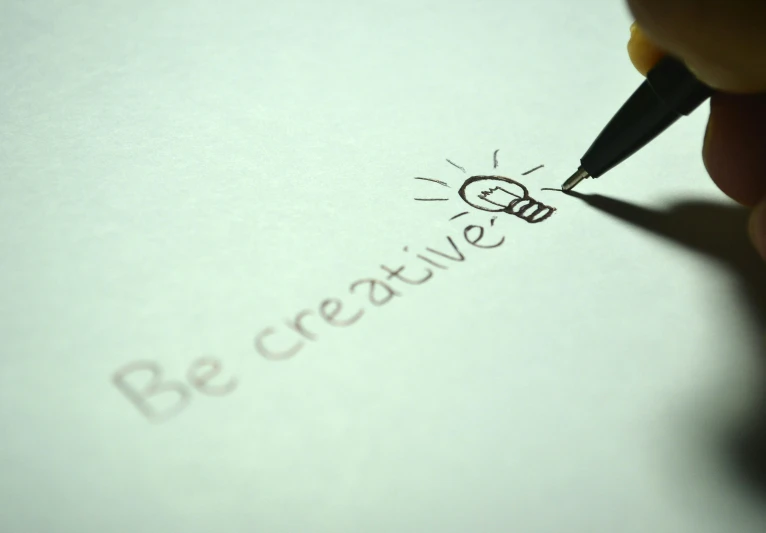 a person writing on a piece of paper with a pen, creativity, innovative, bekinski, promotional picture