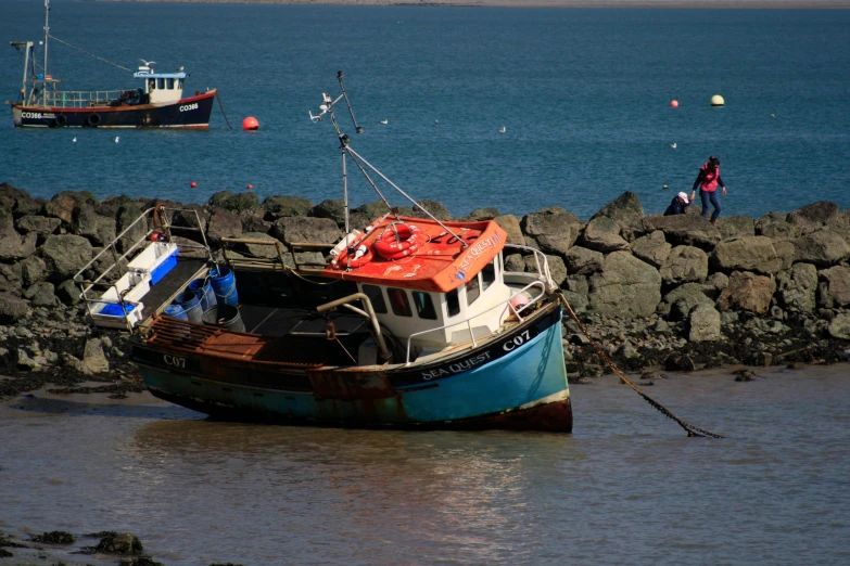 a boat that is sitting in the water, by Thomas Furlong, pexels contest winner, maryport, brightly colored, brown, dua lipa