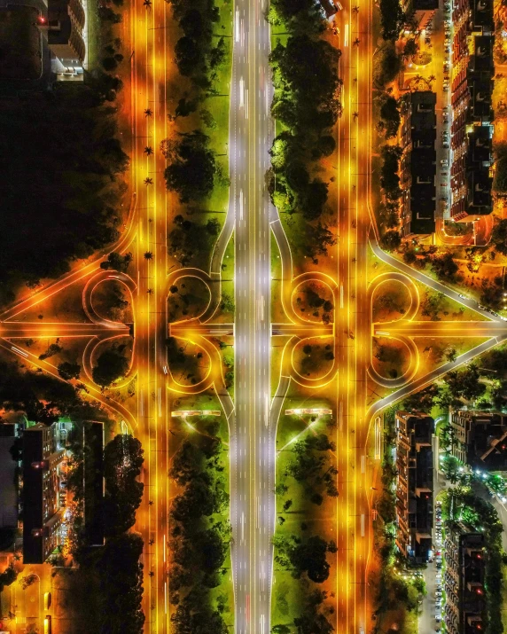 an aerial view of a city at night, an album cover, inspired by David LaChapelle, pexels contest winner, conceptual art, symmetry symmetrical, rainbow road, ultra-detailed digital art, street lighting