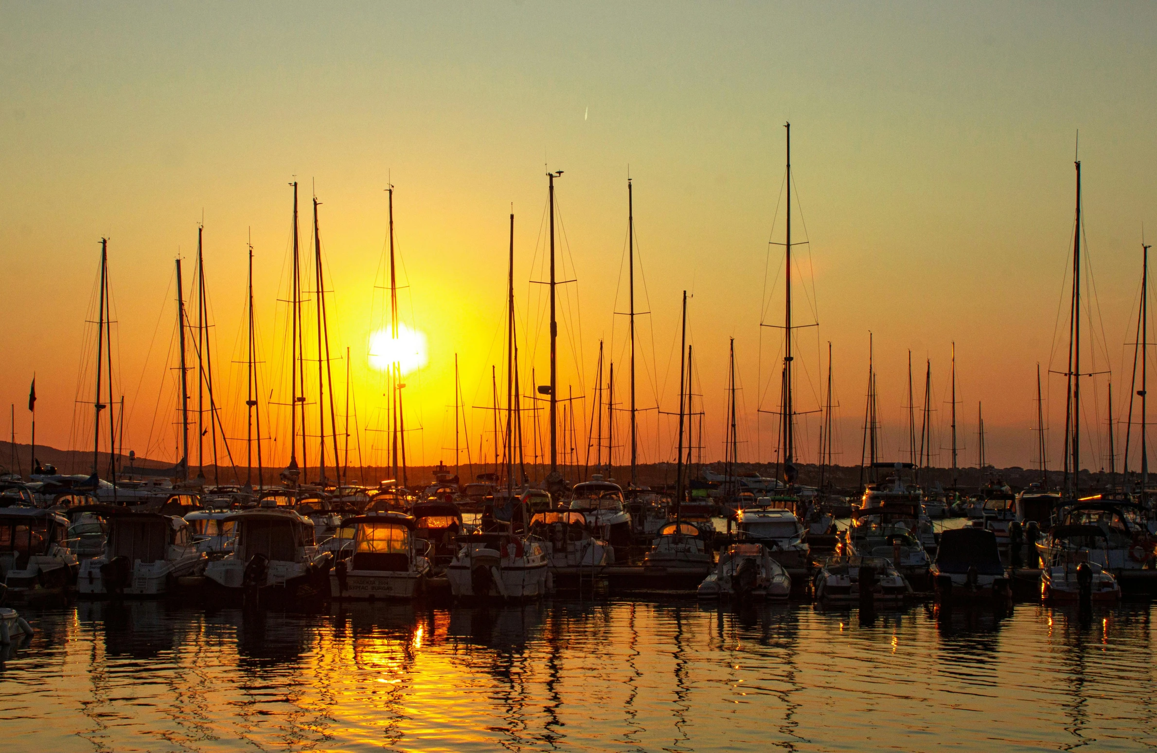 a number of boats in a body of water at sunset, fan favorite, harbor, bored ape yacht club, thumbnail