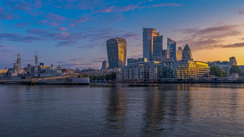 a large body of water with a city in the background, a picture, by Jay Hambidge, pexels contest winner, london south bank, magic hour, 4k panoramic, fine detail post processing