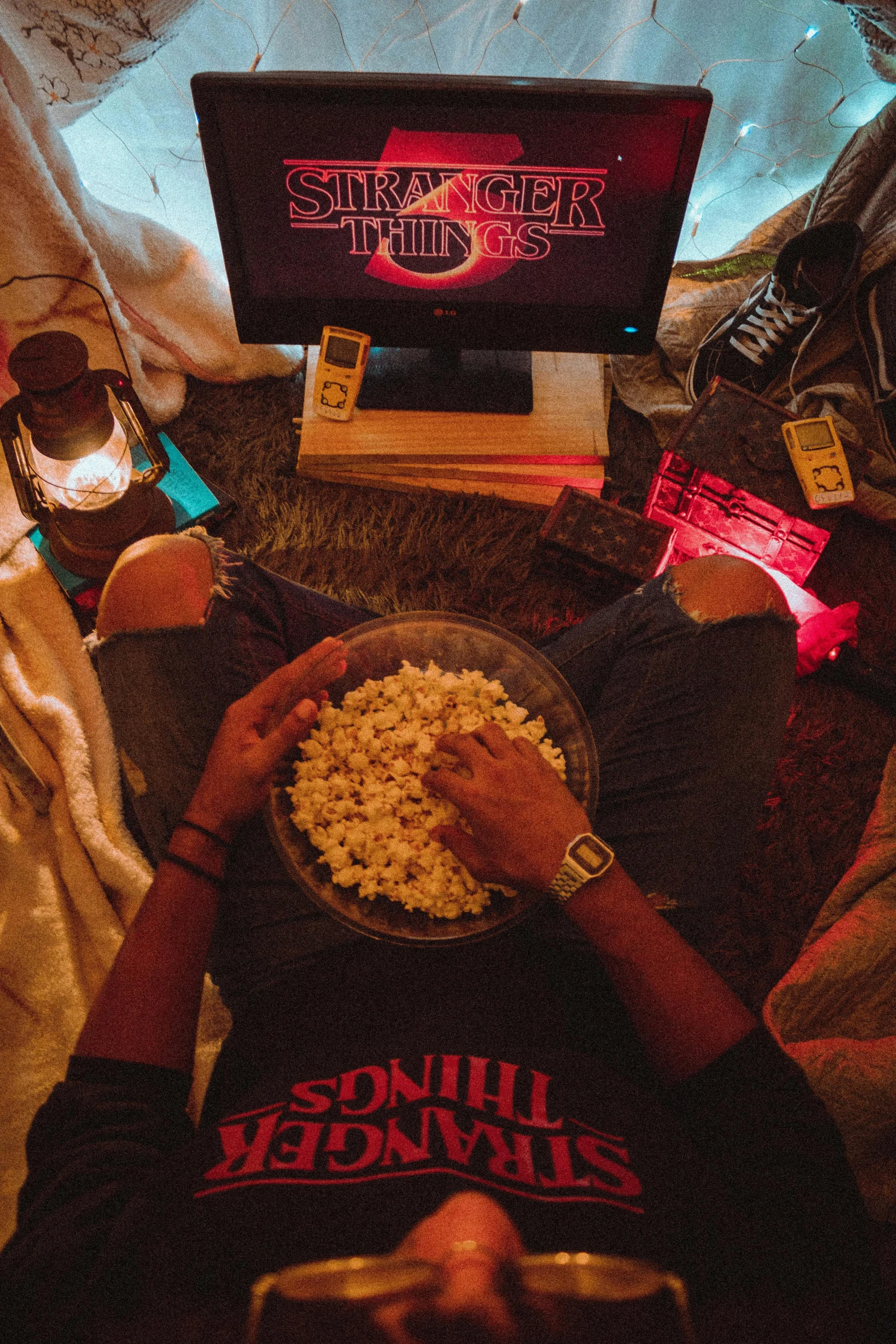 a person laying on a bed with a bowl of popcorn, chillhop, good times, lights on, a high angle shot