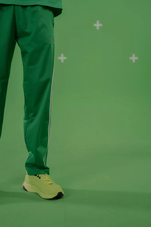 a man in a green suit standing in front of a green background, inspired by Mike Winkelmann, trending on dribble, hyperrealism, detailed shot legs-up, off - white collection, tracksuit, rotoscoped