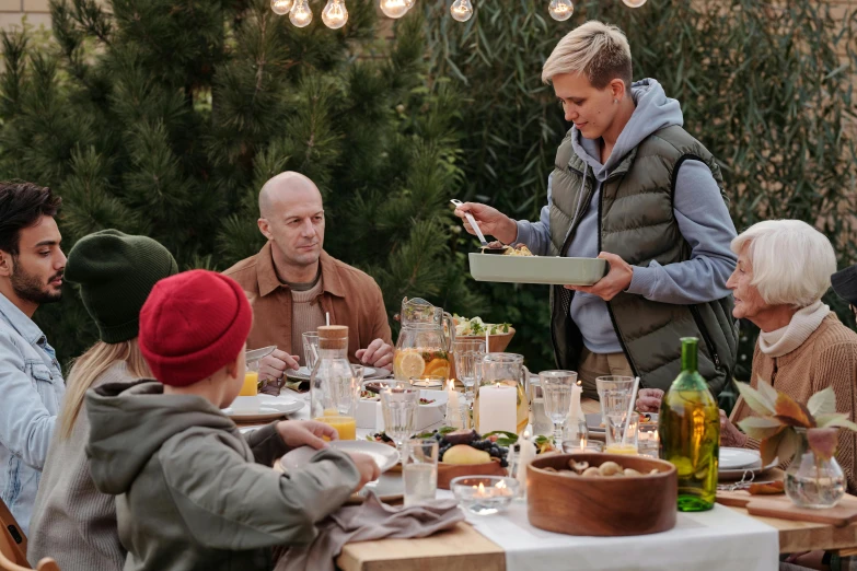 a group of people sitting around a dinner table, by Carey Morris, pexels contest winner, winter setting, handsome man, gardening, a blond