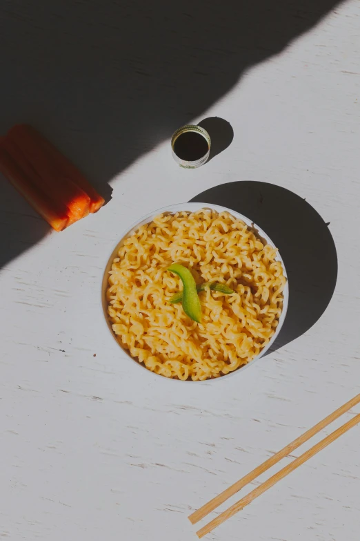 a bowl of noodles and chopsticks on a table, unsplash, photorealism, orange neon, on a sunny day, detailed product image, body made out of macaroni
