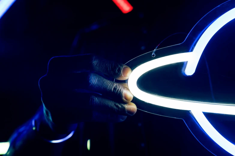 a person holding a neon ring in their hand, by Matt Cavotta, unsplash, interactive art, moon knight, bright signage, holding a pair of fans. unreal 5, infinity mirror