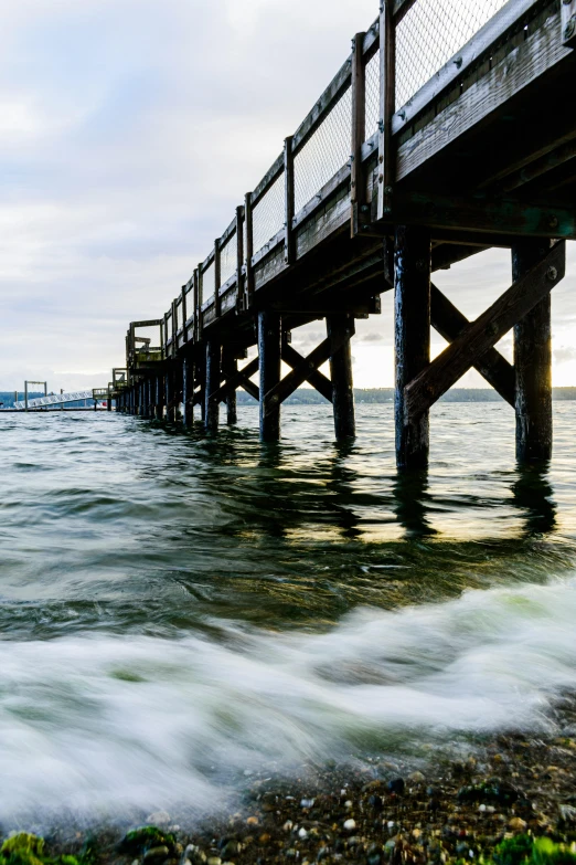 a pier that is next to a body of water, turbulent water, slide show, ultrawide landscape, seattle