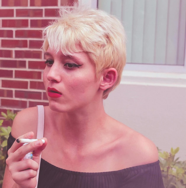 a woman holding a nintendo wii game controller, an album cover, inspired by Elsa Bleda, pexels contest winner, pop art, pixie haircut wlop, smoking a cigarrette🚬, bleached, adi meyers