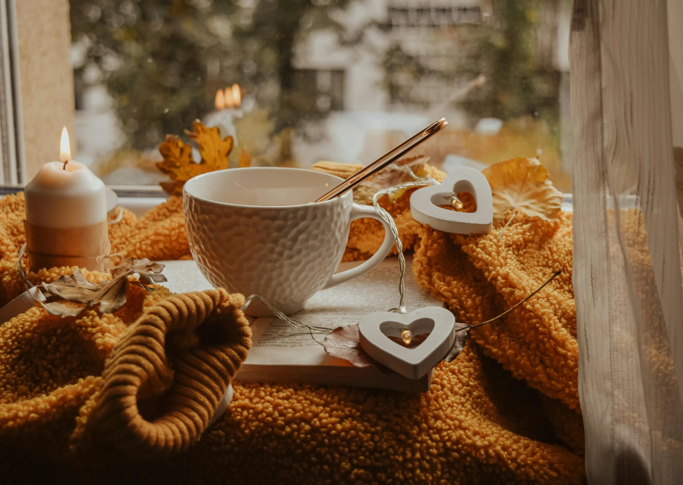 a cup of coffee sitting on top of a window sill, by Emma Andijewska, pexels contest winner, orange and brown leaves for hair, cozy under a blanket, white and gold color scheme, thumbnail