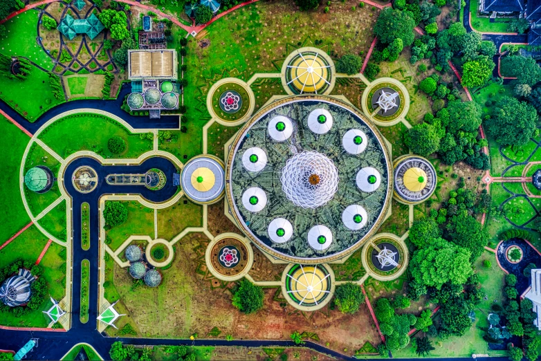 an aerial view of a park with lots of trees, a mosaic, by Ibrahim Kodra, giant lotus mandala, assamese aesthetic, architecture photo, helipad