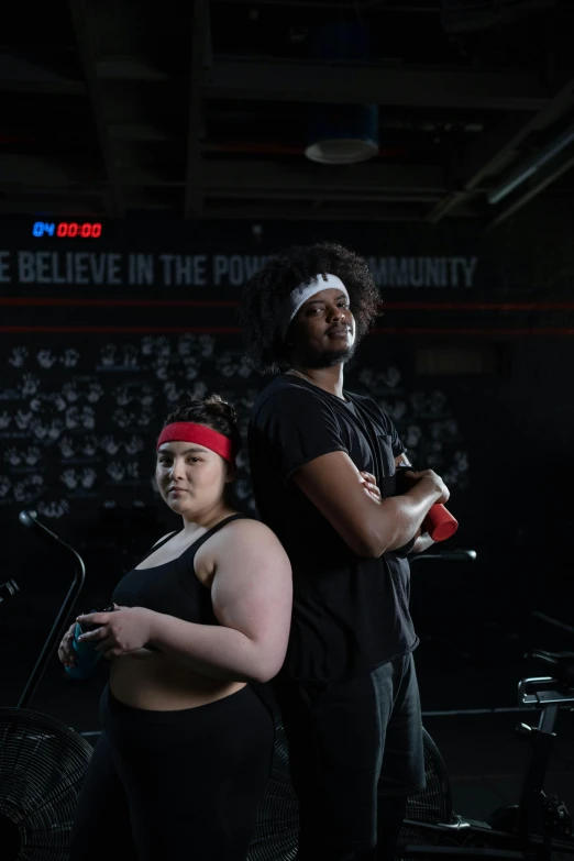 a man and a woman standing next to each other, dim dingy gym, promotional photo, diverse, epk