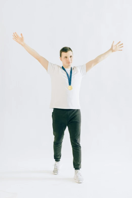 a man with a medal around his neck, an album cover, inspired by Ryan Pancoast, pexels contest winner, with arms up, white backdrop, andrea savchenko, olympics