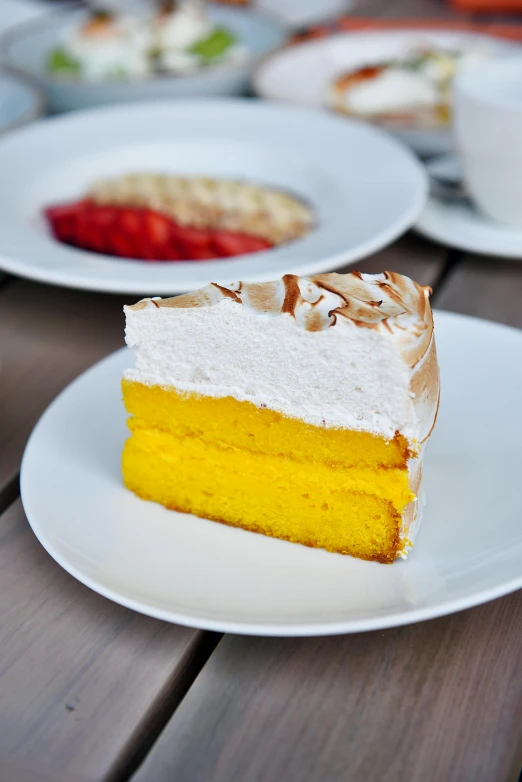 a piece of cake sitting on top of a white plate, yellow-orange, sun coast, order, larapi