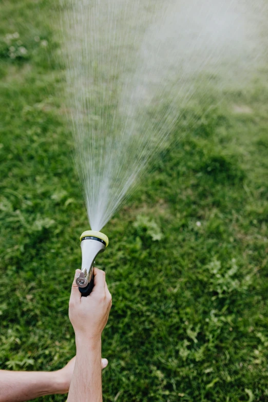 a close up of a person holding a sprinkler, bubbly, lawns, thumbnail, hoses:10