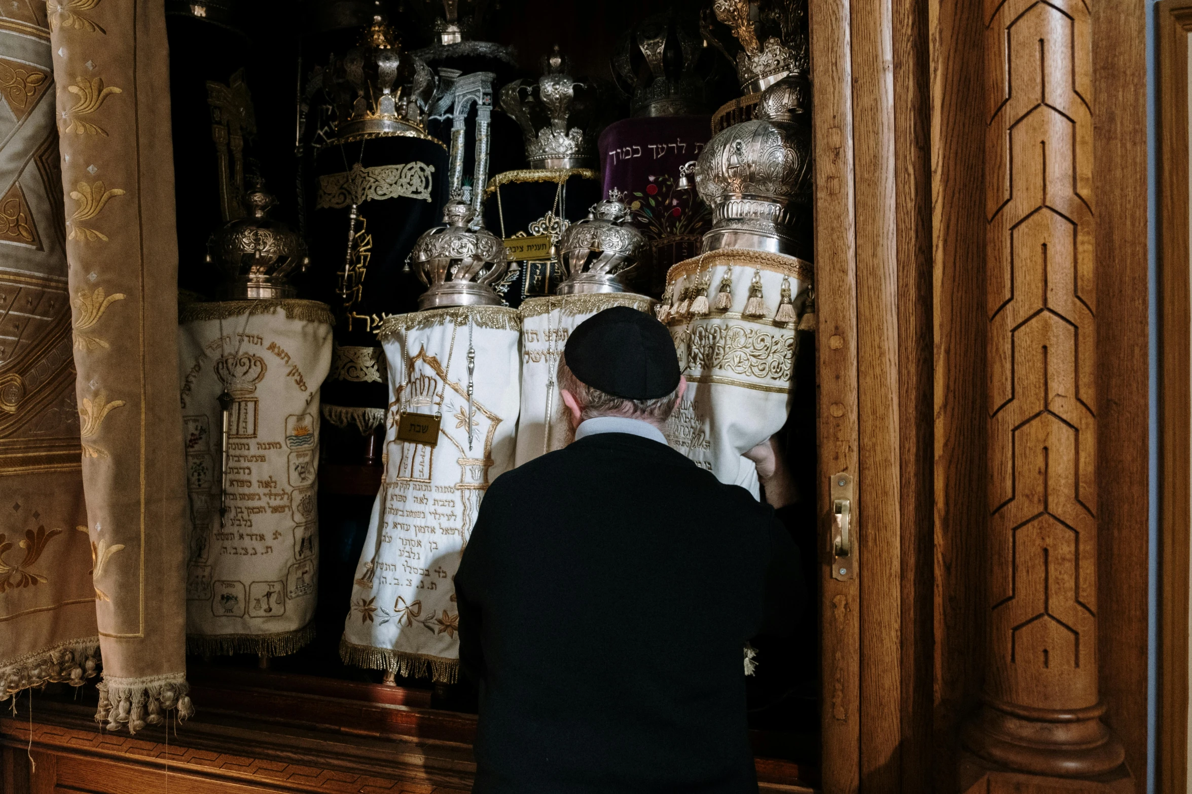 a man is standing in front of a shrine, by Julia Pishtar, pexels contest winner, baroque, hebrew, hiding, decoration, a person standing in front of a
