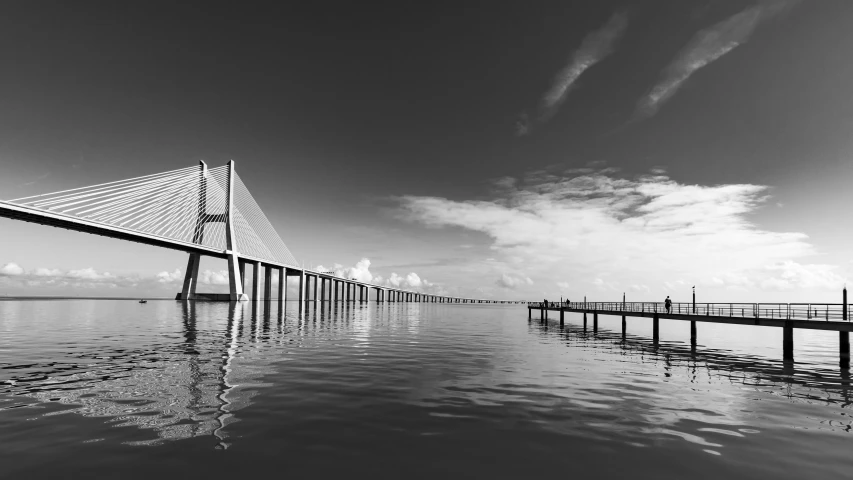 a black and white photo of a bridge, by Joze Ciuha, pexels contest winner, brazil, calm sea, 15081959 21121991 01012000 4k, 256x256