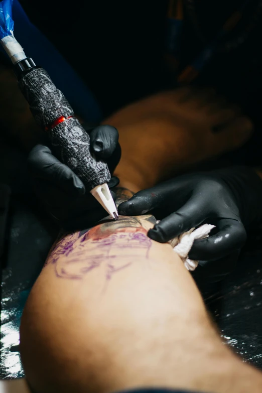 a man getting a tattoo on his arm, a tattoo, trending on pexels, process art, black marker, thigh skin, rips, colored