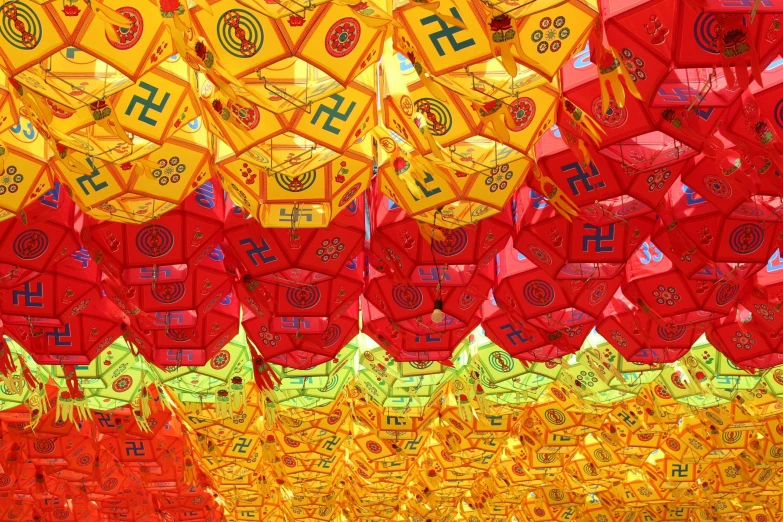 a bunch of red and yellow paper lanterns hanging from the ceiling, inspired by Wu Wei, pexels, square, parasols, hindu aesthetic, korean symmetrical face