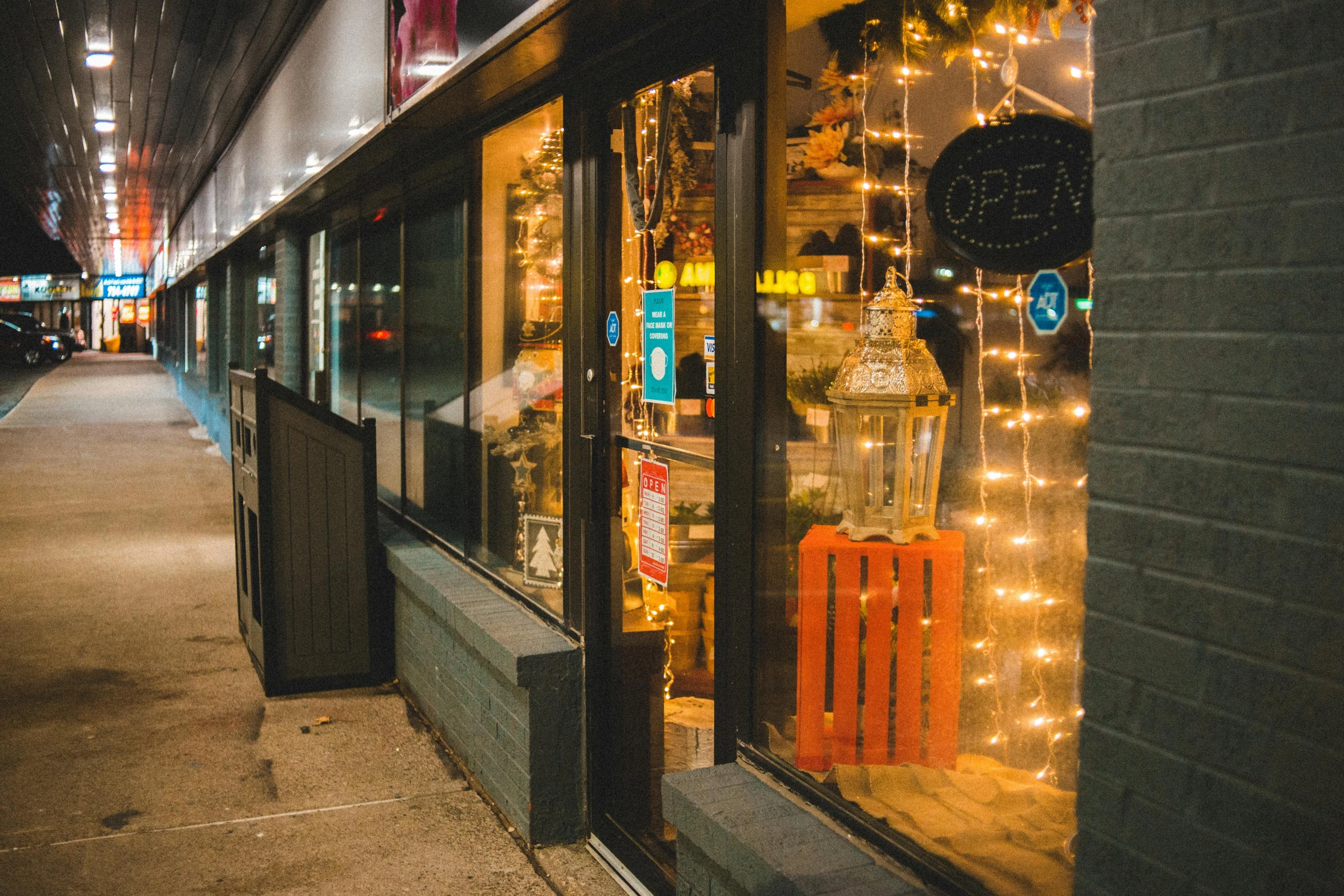 a store front on a city street at night, fan favorite, cozy lights, thumbnail