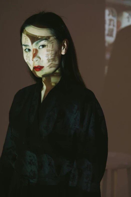 a woman standing in front of a projection screen, inspired by Taro Yamamoto, unsplash, portrait made of paint, wearing black silk robe, close-up portrait film still, asian woman