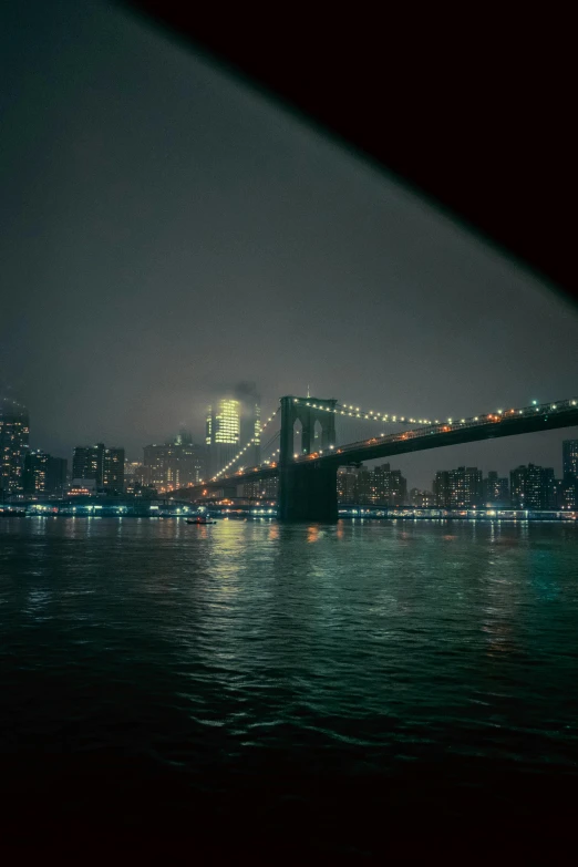 a bridge over a body of water at night, a picture, inspired by Elsa Bleda, new york buildings, 2022 photograph, cities, slide show