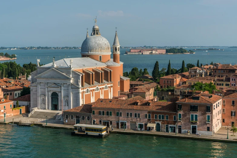 a large building next to a body of water, a photo, by Canaletto, pexels contest winner, alvaro siza, promo image, byzantine, viridian and venetian red