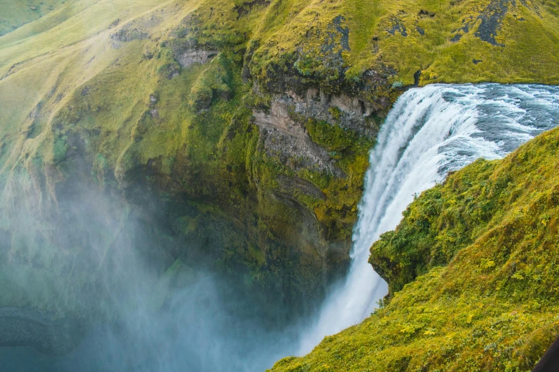 a waterfall in the middle of a lush green valley, pexels contest winner, hurufiyya, thumbnail, nordic, conde nast traveler photo, teaser