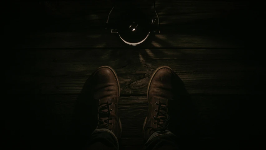 a pair of brown shoes sitting on top of a wooden floor, an album cover, by Elsa Bleda, pexels contest winner, scary lighting, camera looking down upon, jack baker from resident evil 7, instagram post