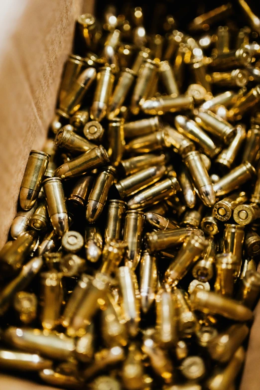 a box filled with lots of gold bullet casings, close up guns and roses, tanks, bay area, thumbnail