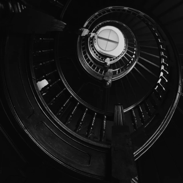 a black and white photo of a spiral staircase, by Adam Chmielowski, unsplash contest winner, baroque, dark vintage sci fi, dark ( spaceship ), eight eight eight, 38mm photograhpy